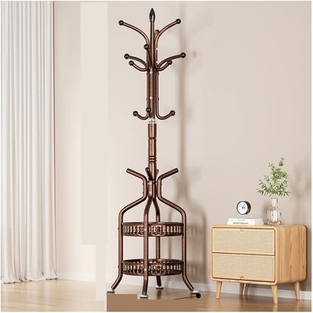 A brass-colored metal coat rack with double shelves, standing on a floor next to a wooden side table with a plant and a clock.