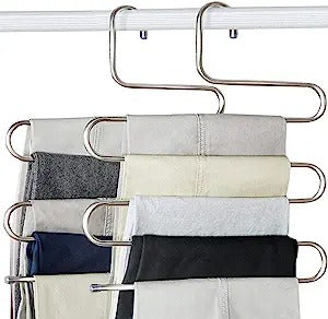 A set of stainless steel trouser hangers holding multiple pairs of trousers and other clothing items in an overlapped arrangement.