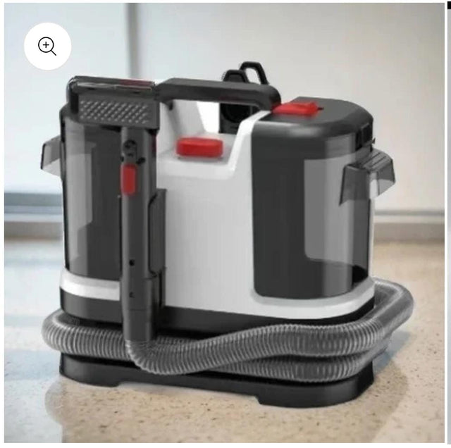A compact, upright Multifunctional Sofa Cleaning Machine with a white body, black accents, and a clear dustbin.