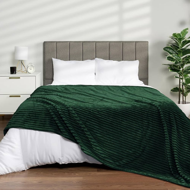Emerald Green: Ribbed fleece blanket emerald green flannel on bed bedroom — iDecorators Kenya