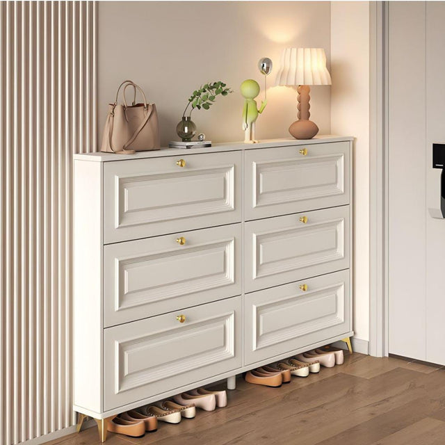 Modern cream white flip shoe cabinet with six tipping compartments and gold handles for stylish entryway shoe storage and home organization.