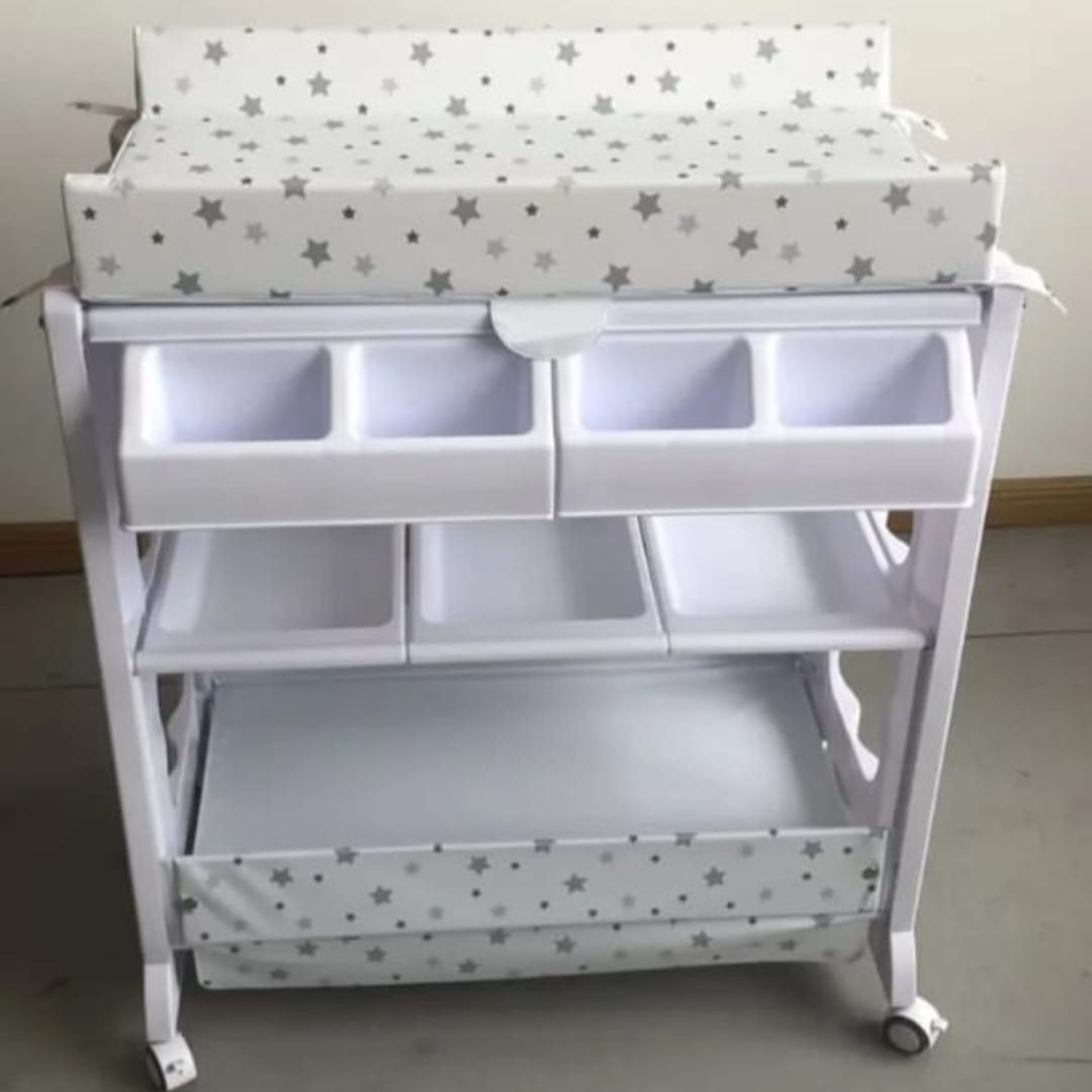 Baby Bath and Changing Station
A convenient all-in-one solution for baby care, combining a padded changing table with multiple storage compartments and a built-in baby bath.
Key Features:
Dual Function: Combines changing table and baby bathtub
Soft Changing Pad: Cushioned top with star-print cover for baby comfort
Ample Storage: Multiple compartments for diapers, wipes, clothes, and essentials
Mobility: Equipped with lockable wheels for easy movement
Hygienic & Practical: Easy to clean and perfect fo