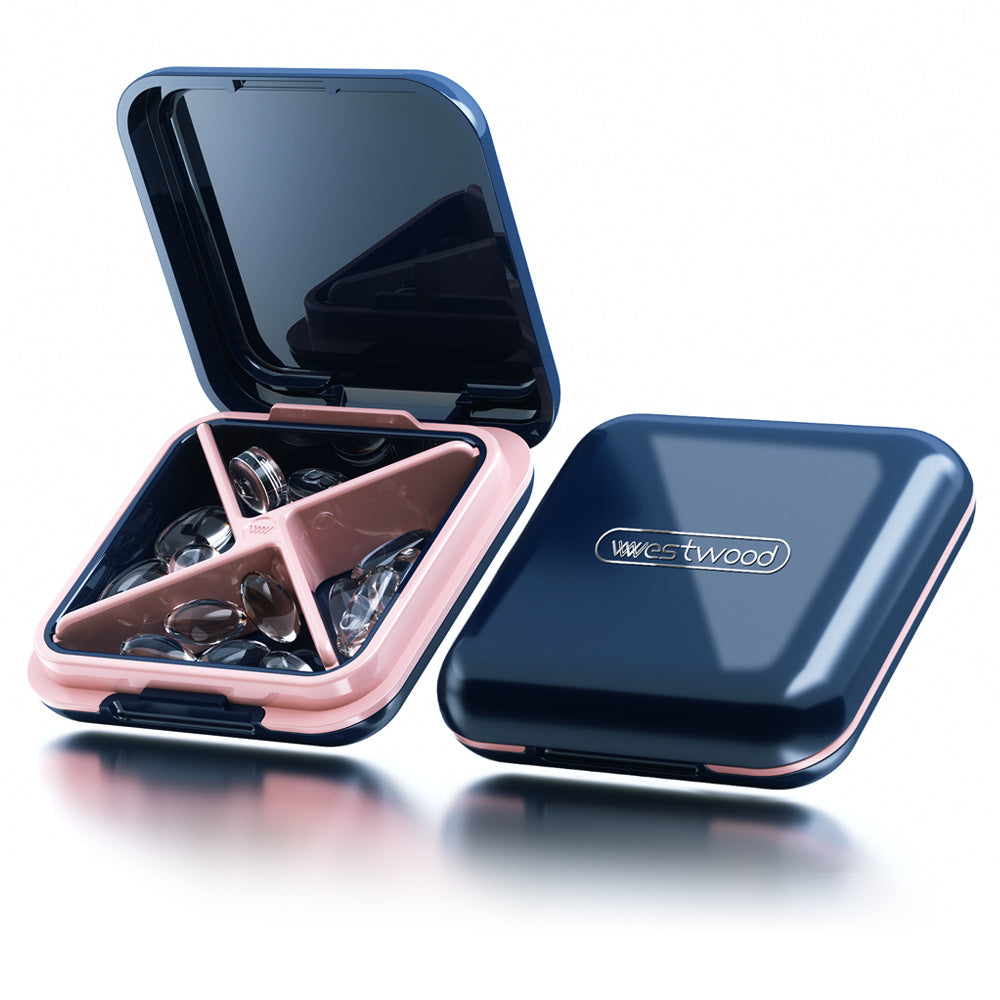 Blue and rose gold pill case with visible brand logo on a white background