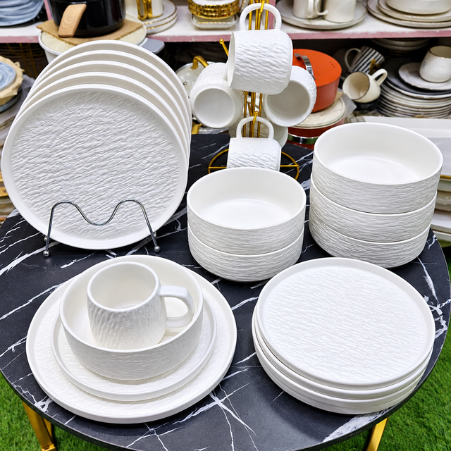 Dinner set white textured ceramic with dinner plates, side plates, bowls and mugs on gold mug stand, black marble table — iDecorators Kenya
