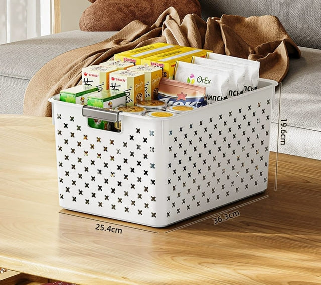 A white large size storage basket filled with various items like books and snacks, placed on a wooden surface with dimensions marked on the image.