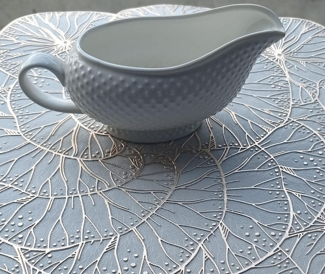 Ceramic dotted saucing jug.