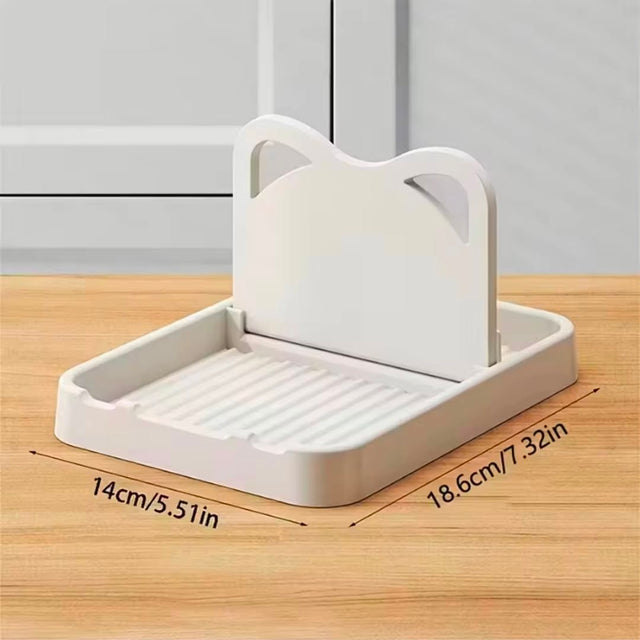 Kitchen pot lid and utensil holder with drip tray for organizing pan lids, spoons and cooking utensils on the countertop.