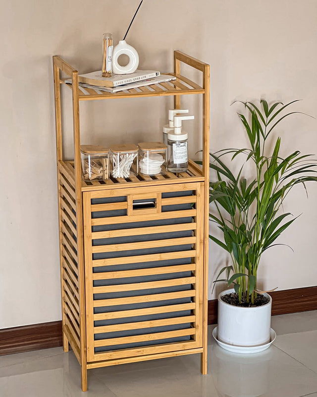Bamboo laundry hamper with a removable fabric laundry basket and two-tier storage shelves, ideal for organizing laundry, toiletries, towels, and bathroom essentials.