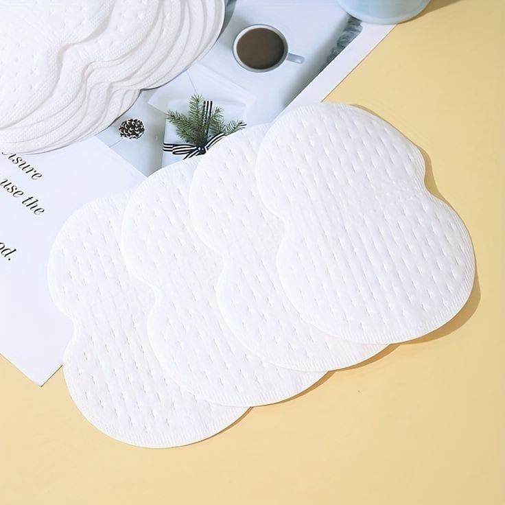 White silicone mats on a yellow surface with a magazine and coffee cup in the background