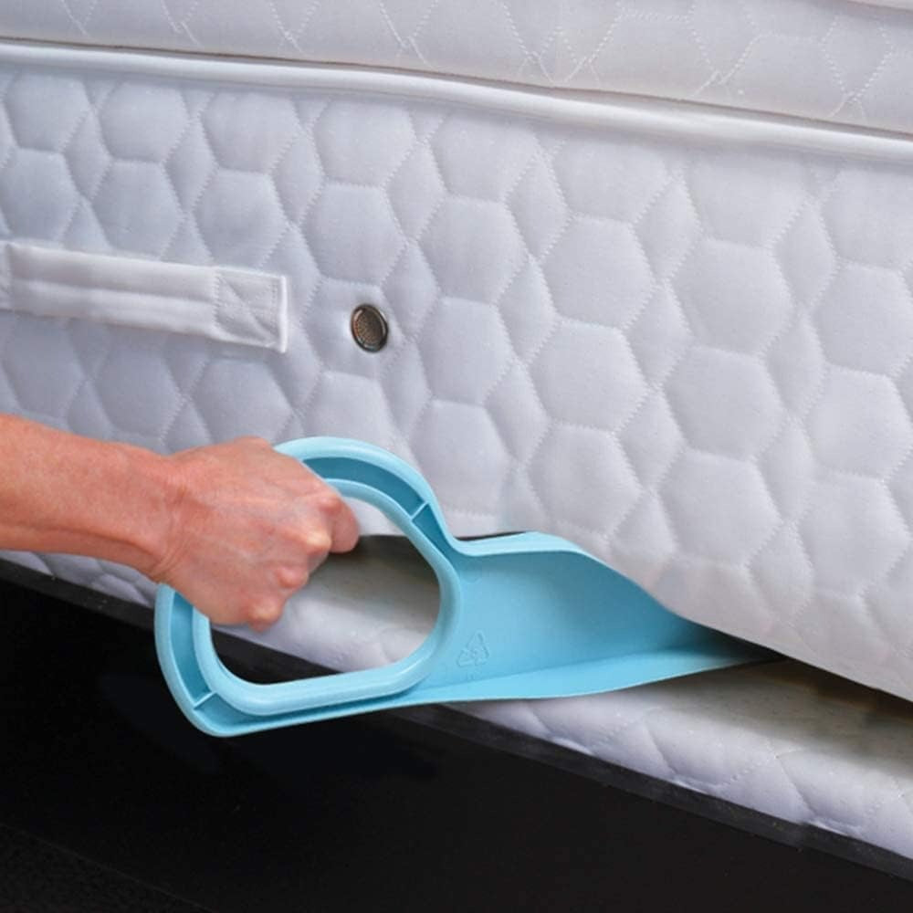 A tool being used to lift a mattress, with a blue handle and a white mattress pad.