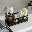 Metal sink caddy organizer with adjustable dividers and drain tray for storing sponges, soap, brushes and cleaning supplies.