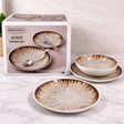 Dinner set with decorative plates and bowls in front of a Danny Home packaging box.