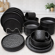 Set of black ceramic dinnerware on a kitchen counter