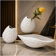 Modern white textured ceramic vase set with matching decorative bowl displayed on a marble tabletop.