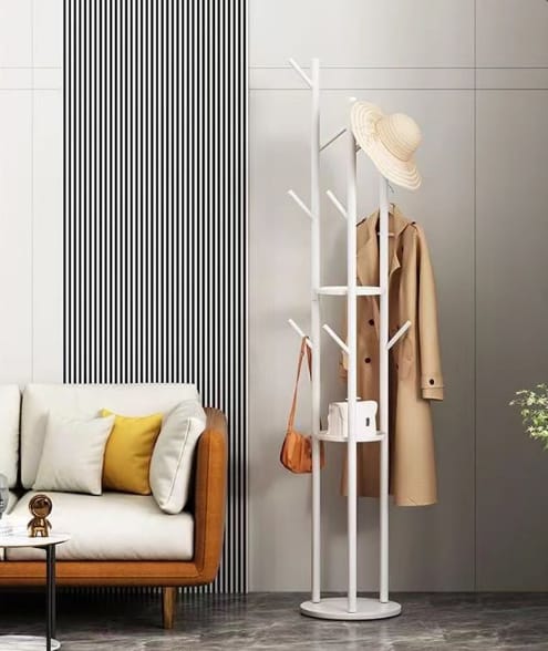 Modern gold metal coat rack stand with storage shelves for hats, clothes, umbrellas, and flower pots in a stylish home interior.