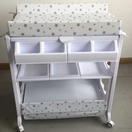 Baby Bath and Changing Station

A convenient all-in-one solution for baby care, combining a padded changing table with multiple storage compartments and a built-in baby bath.

Key Features:

Dual Function: Combines changing table and baby bathtub

Soft Changing Pad: Cushioned top with star-print cover for baby comfort

Ample Storage: Multiple compartments for diapers, wipes, clothes, and essentials

Mobility: Equipped with lockable wheels for easy movement

Hygienic & Practical: Easy to clean and perfect fo