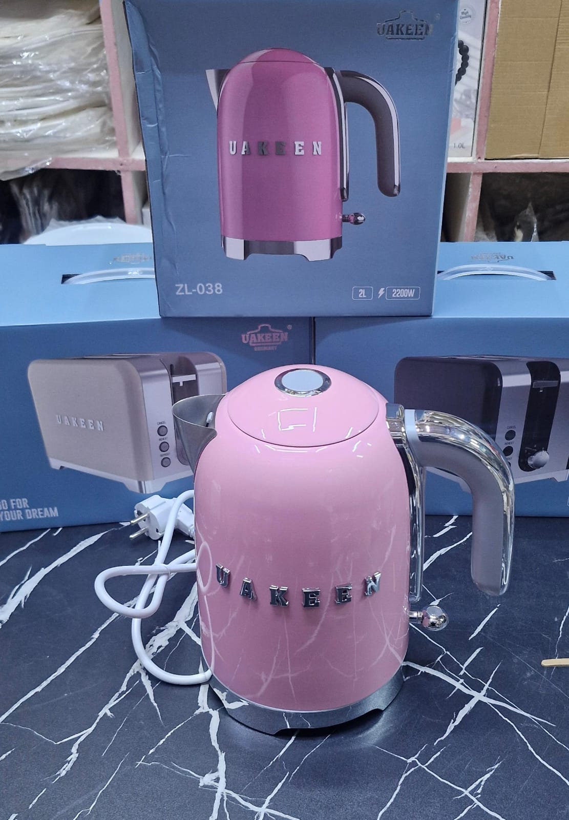 UAKEEN ZL-038 2L 2200W retro pink electric kettle with chrome 3D lettering, transparent chrome handle and chrome dome lid on marble surface
