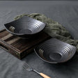 Stoneware Black Sizzling Bowl

Material: Durable stoneware, ideal for high-heat serving and oven use

Color: Sleek matte black finish for a modern, professional look

Function: Perfect for serving sizzling hot dishes like meats, stews, or stir-fries

Design: Heat-retaining build keeps food warm at the table, enhancing presentation and flavor