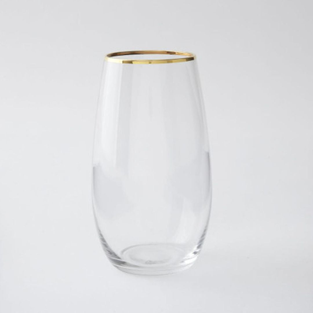 A clear glass with a gold rim at the top, isolated on a white background.