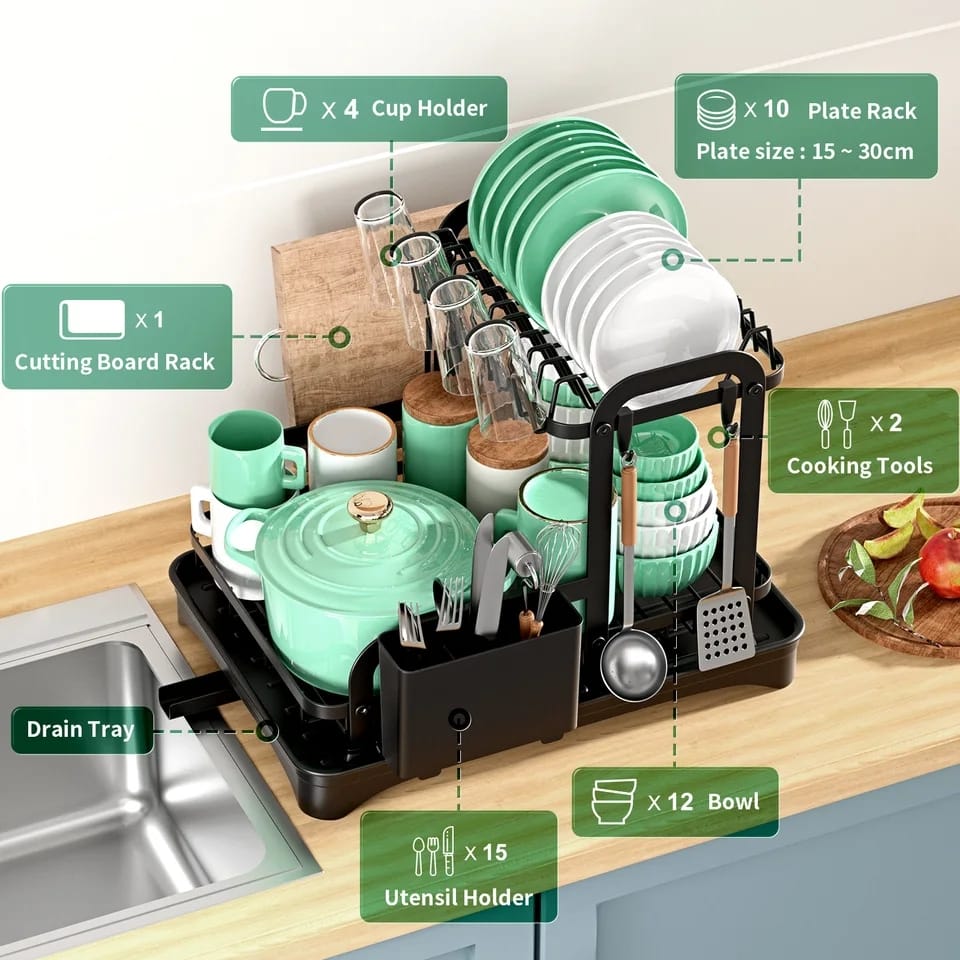 A black two-tier dish drying rack with a drip tray, featuring utensil holder, spoon holder, and a chopping board rack, displayed in a kitchen setting.