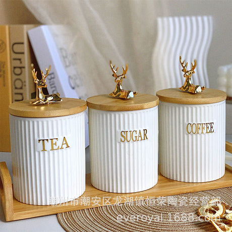 * Porcelain ceramic canisters
* Bamboo lids for freshness
* Comes with bamboo tray & gold reindeer décor
* Elegant and durable kitchen storage