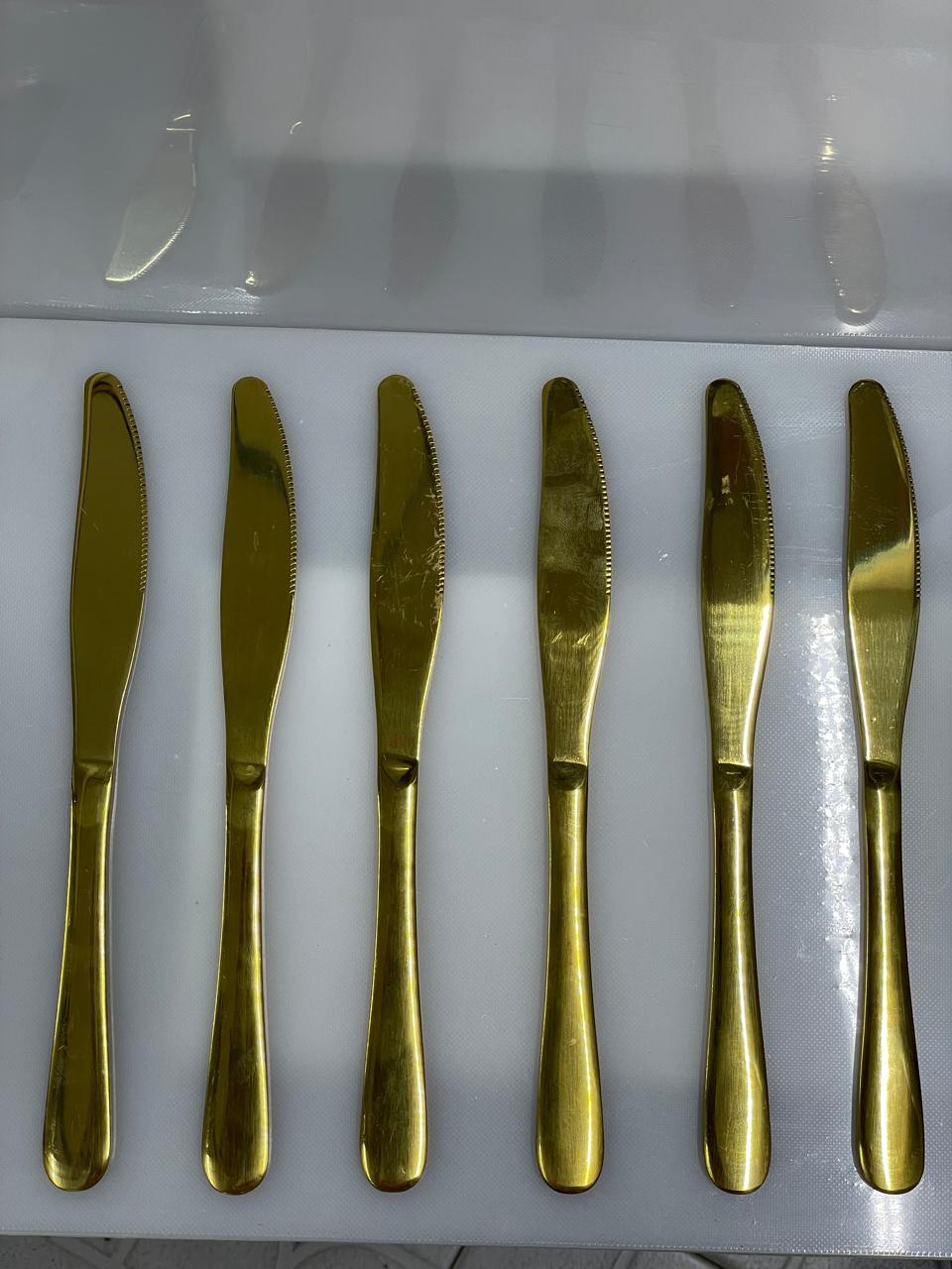 Set of six gold butter knives 