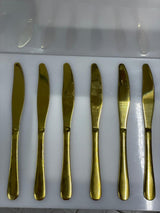 Set of six gold butter knives 