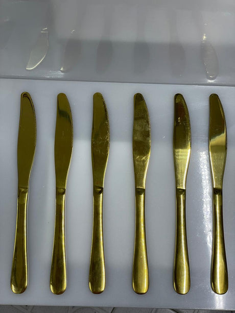 Set of six gold butter knives 