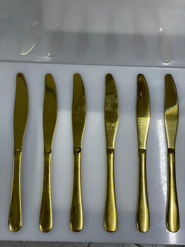 Set of six gold butter knives 