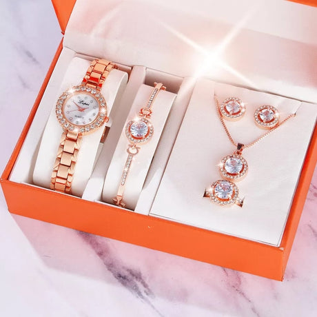 Rose gold jewelry set including a watch, bracelet, and earrings in an orange box.