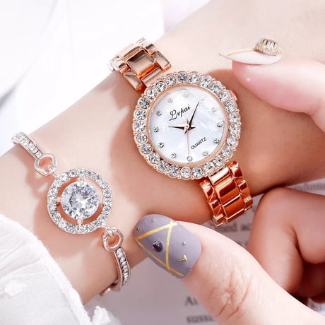 Rose gold watch with diamond accents on a wrist, close-up view.