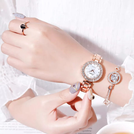Rose gold watch on a wrist with a white background