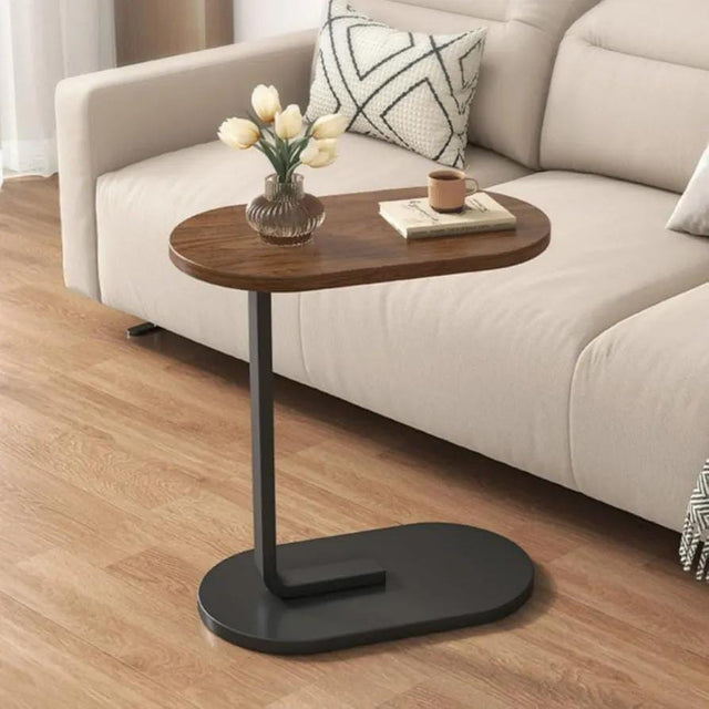 Wooden side table with black base in a living room setting