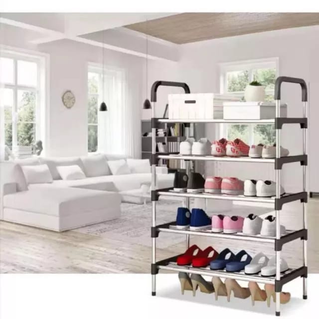 A 6-tier metal shoe rack organizer with shoes arranged on it, placed in a bright living room setting.