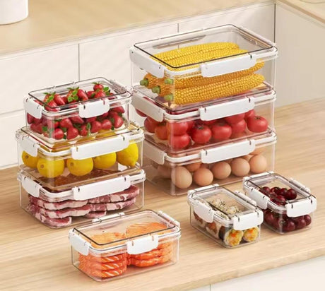 Set of clear food storage containers with various food items on a wooden surface.