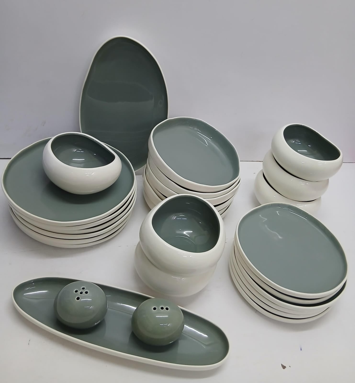 Modern sage green and white ceramic dinner set with plates, bowls, serving dishes and salt and pepper shakers