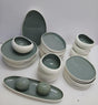 Modern sage green and white ceramic dinner set with plates, bowls, serving dishes and salt and pepper shakers