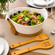 Serve salads in style with this ceramic salad bowl featuring a bamboo stand and matching serving utensils. Perfect for modern kitchens and entertaining.