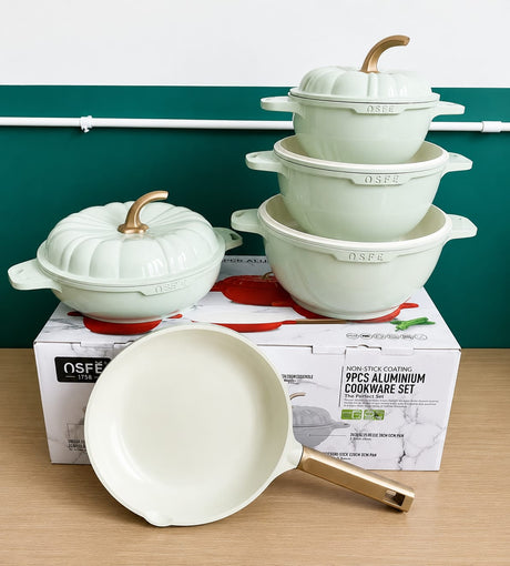 9-piece non-stick aluminium cookware set with three casserole pots, lids, and frying pan in a modern pumpkin design.