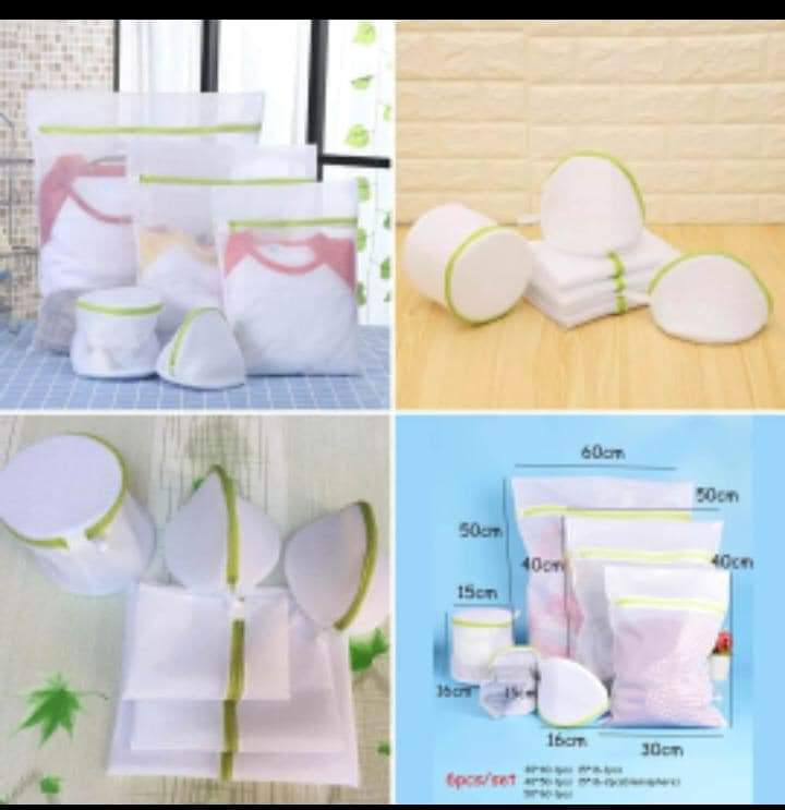 A set of white mesh laundry bags with green trim, displayed in various sizes and being used to wash different articles of clothing.