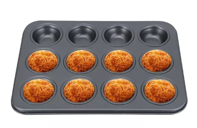 A standard-sized cupcake tray with non-stick surface, containing cupcakes in a baking setting.