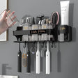 Black wall-mounted bathroom organizer with toothbrush holder, rinsing cups, storage shelf and hanging hooks