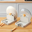 Kitchen pot lid and utensil holder with drip tray for organizing pan lids, spoons and cooking utensils on the countertop.