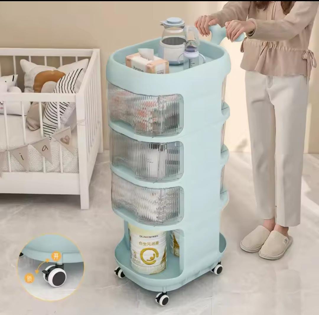 A blue multi-tier baby supplies shelf with wheels, shown with various baby items organized on it, and an adult pushing the shelf with a baby in the background.