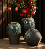 Dark green textured ceramic vase set with gold accents in three sizes displaying decorative floral arrangements.
