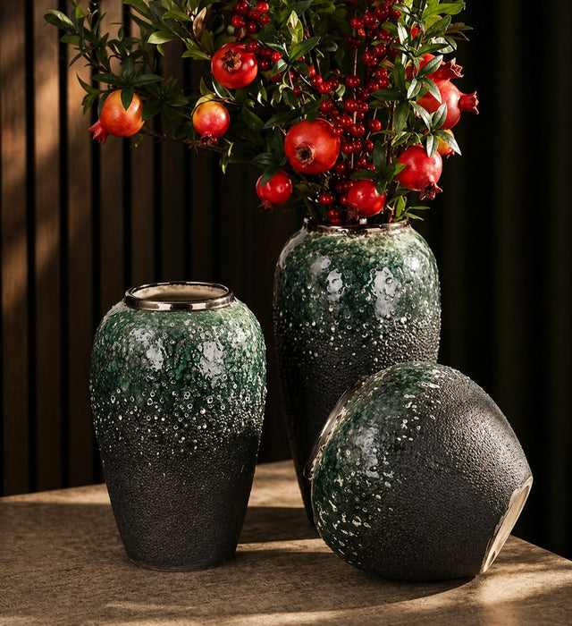 Dark green textured ceramic vase set with gold accents in three sizes displaying decorative floral arrangements.