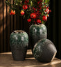 Dark green textured ceramic vase set with gold accents in three sizes displaying decorative floral arrangements.