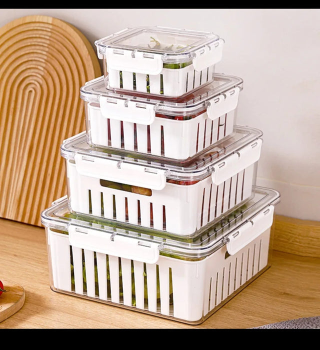 Fresh produce storage containers with drain baskets and airtight lids for organizing fruits and vegetables in the refrigerator.