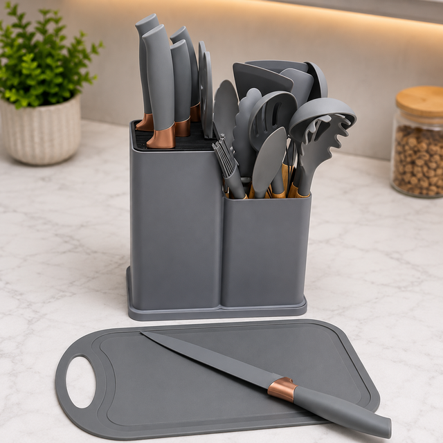 Grey silicone kitchen utensil set with wooden handles, storage holder, tongs, whisk, spatulas and cutting board
