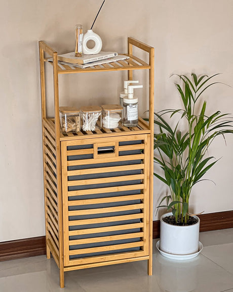 Bamboo laundry hamper with a removable fabric laundry basket and two-tier storage shelves, ideal for organizing laundry, toiletries, towels, and bathroom essentials.